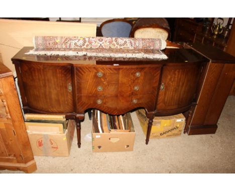 A reproduction mahogany serpentine front sideboard fitted three drawers 