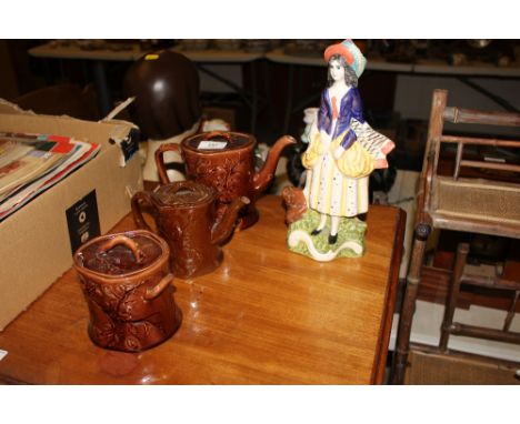 A Staffordshire style figurine; together with an oriental design teapot, one other similar and a preserve jar