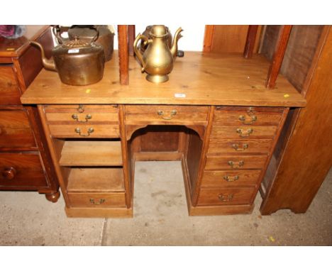 An early 20th Century stripped pine desk fitted multiple drawers 