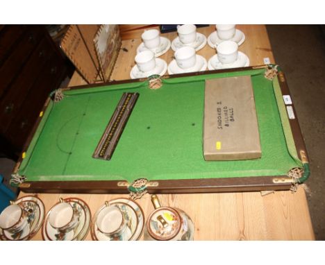 A table top snooker table and balls 