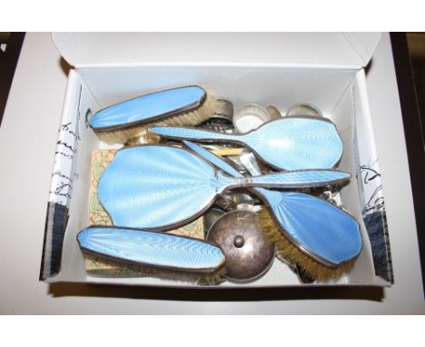 A box containing blue enamel dressing table brushes and a hand mirror, cutlery etc. 