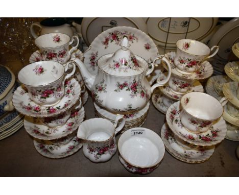 A Royal Albert Lavender Rose tea set comprising eleven cups, twelve saucers, side plates, cake plate, tea pot, cream jug and 