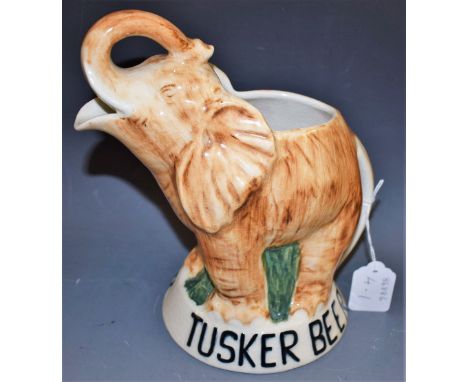 A novelty South African Drostdy Ware beer jug, modelled as an elephant with raised trunk, for Tusker Beer, 24cm high, printed