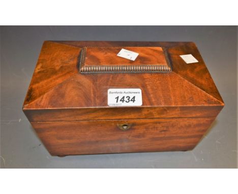 A mahogany sarcophagus tea caddy on bun feet