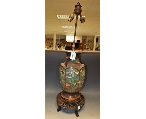 A late 19th Japanese cloinsonne twin handled urn table lamp, decorated with flowers, serpent handles, pierced wooden base, el