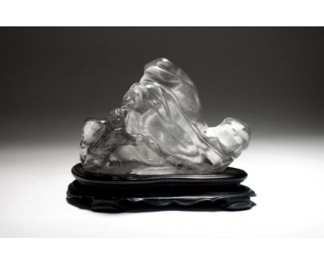 A Chinese rock crystal carving of a tiger on rock, Qing, modelled as a tiger, the natural inclusions in the stone forming its