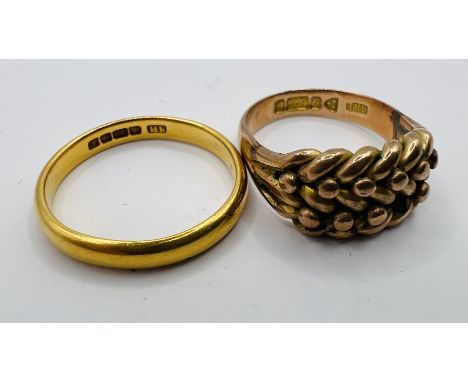 An 18ct gold keeper ring along with a 22ct gold band ring. The keeper ring is an estimated 5.4 grams, size M; the band approx