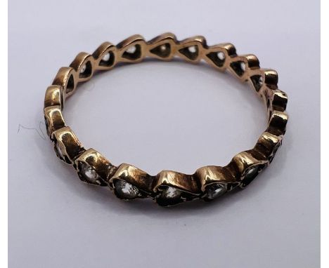 A full eternity ring with the synthetic spinel stones set into heart settings. Stamped 9ct. Gross weight approximately 1.4 gr