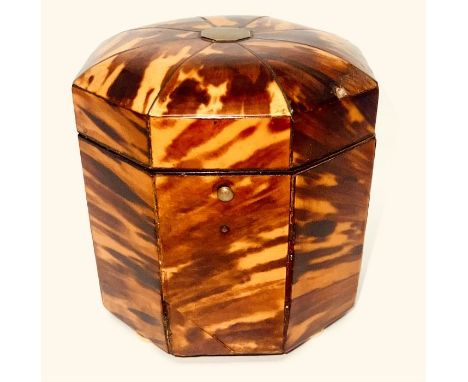A Regency tortoiseshell tea caddy, circa 1810, in an octagonal shape with dome hinged lid, enclosing an ivory handled interio