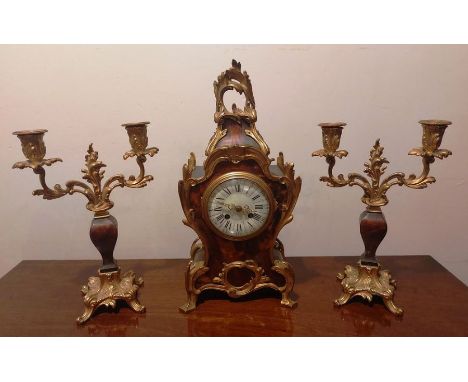 A French Louis Boulle tortoise shell style mantle clock and matching candlestick garniture. 8 day French two train movement s