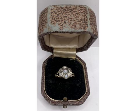 An opal and old mine cut diamond flowerhead ring, size F. Approximate weight 1.9 gram