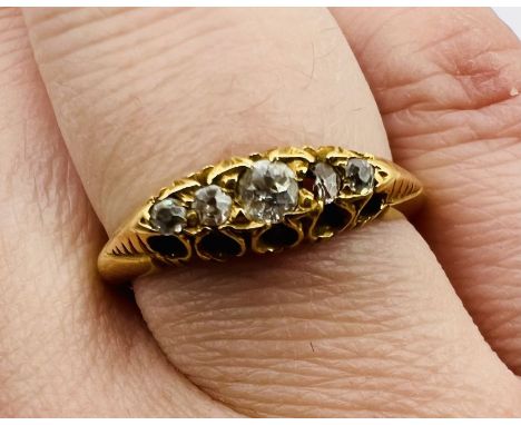 An 18ct yellow gold ring set with five diamonds. Size Q. Gross weight approximately 3.8 grams. Please note one of the stones 