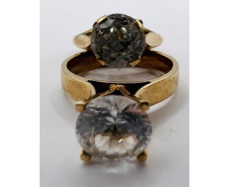 Two unmarked yellow metal rings, one set with cubic zirconia (size M, gross weight approximately 3.3 grams); the other a whit