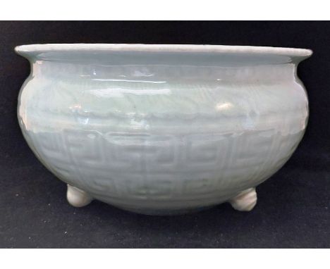 A Chinese Celadon porcelain bowl Qing Dynasty 18/19th C semi-ovoid, moulded bands of key pattern, on button feet, measures 24