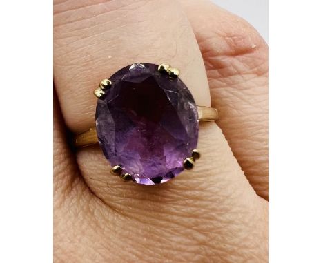 A 9ct gold amethyst cocktail ring. The amethyst is a mixed cut oval, measuring approximately 12mm x 10mm x 6mm approximately,