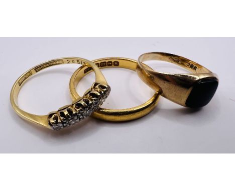 A selection of three rings. Comprising an 18ct stamped diamond half hoop ring (approximate weight 2.1 grams); a 22ct band rin