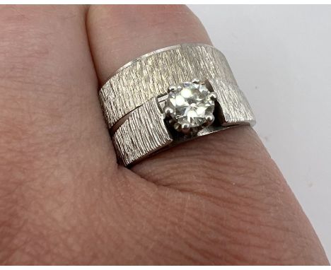 Two gold rings. A 9ct gold textured band ring, approximate weight 4.2 grams, along with a textured diamond solitaire ring in 
