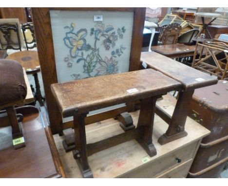 A pair of trestle stools, another and an embroidered fire screen