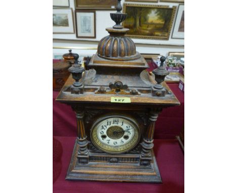 A walnut architectural cased mantle clock, 8 day German movement striking on a coiled gong. 17½'' high