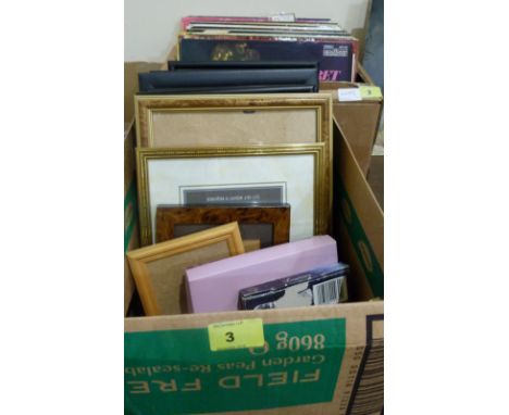 A box of long playing records and a box of frames