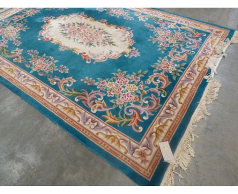 A blue ground Chinese carpet. 138'' x 100''. Light staining