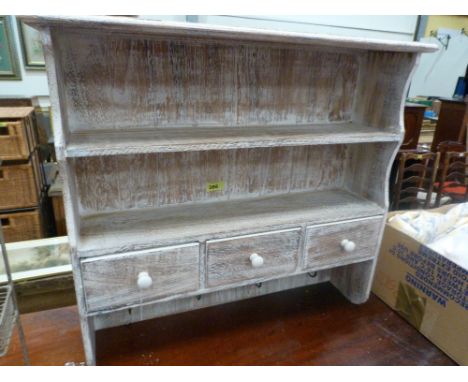 A limed oak hanging shelf with three spice drawers. 25'' wide