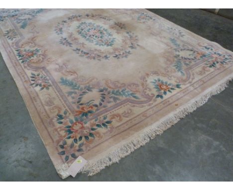 A cream ground Chinese carpet. 144'' x 110''. Some staining