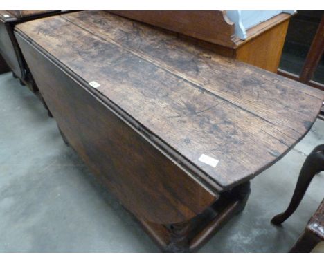 A late 17th/ early 18th century joined oak gate leg table with two frieze drawers, on barley twist legs. 53'' wide