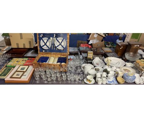 A wicker picnic hamper with cutlery, plates and storage containers together with a large collection of drinking glasses, Clue