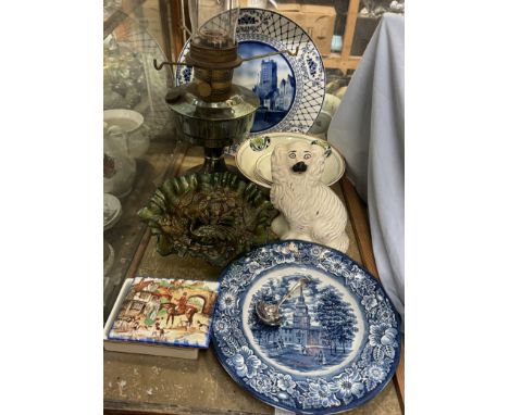 A carnival glass dish decorated with a peacock and urn together with assorted plates, a white metal oil lamp, Staffordshire d