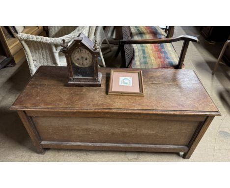 An oak coffer with a rectangular top and panelled front on square legs together with a mantle clock and Fiona Owen watercolou