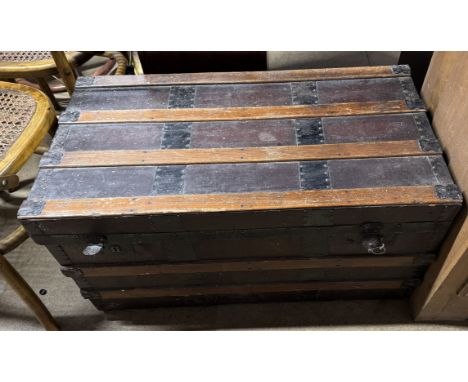 A rectangular hinged banded trunk