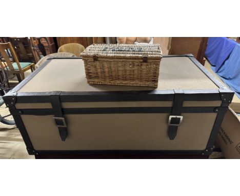 A linen and leather trunk coffee table together with a Fortnum and Masons basket