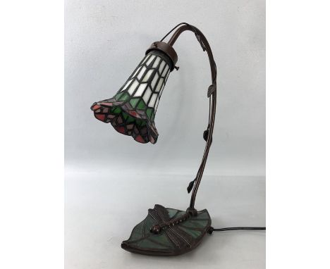 Tiffany style table lamp with a dragonfly and leaf base