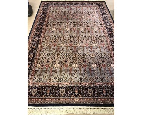Rose ground carpet with blue borders, approx 310cm x 200cm