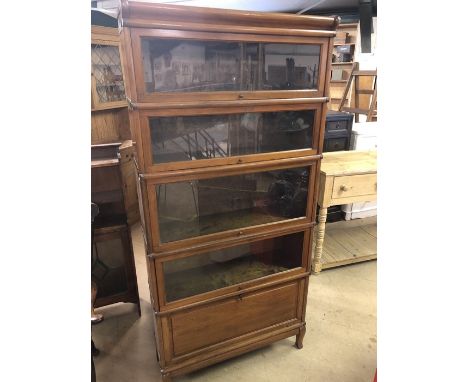 Five section Globe Wernicke English-made bookcase with metal bindings, stands approx 183cm tall, with four glass fronts and o