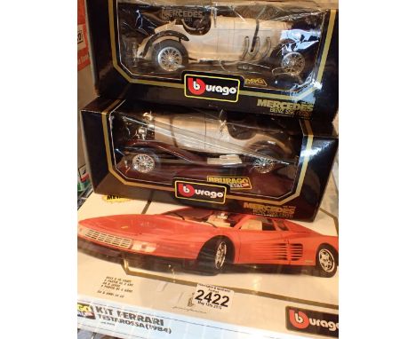 Two Burago diecast vehicles and a Ferrari kit