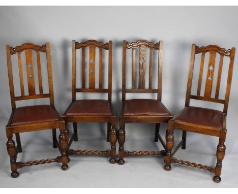 A Set of Four Oak Framed Dining Chairs with Barley Twist Supports and Bar Backs with Central Splat Having Pierced Arrow Heart