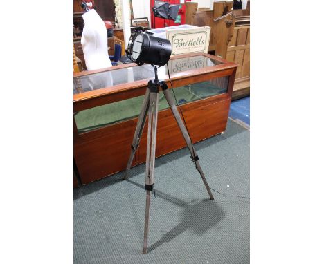 A Modern Interior Light in the Form of a Theatre Spotlight Mounted on Tripod 