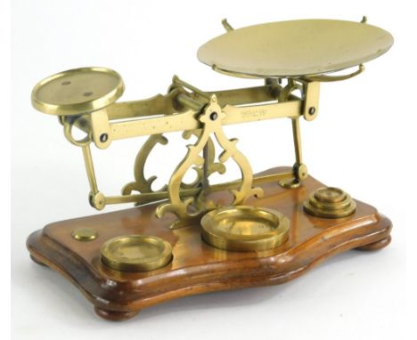 A set of late 19thC/early 20thC scales, with removable plate and weights and a serpentine base, terminating in compressed bun