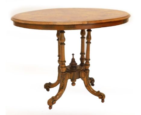 A Victorian walnut occasional table, the circular quarter veneered top with inlaid border on four turned supports with carved