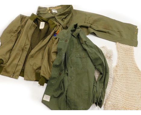 A Second World War winter combat jacket, size Medium, label for De Brander Co, dated February 29 1942, string vests dated fro