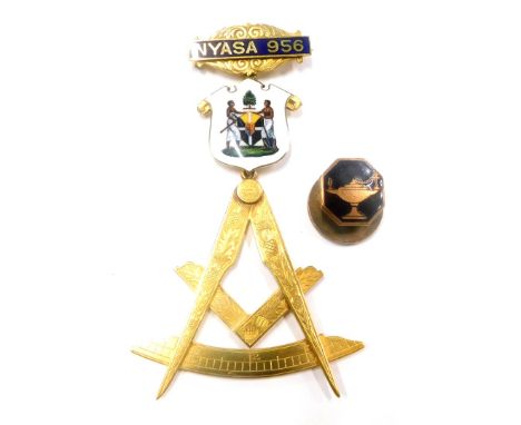 A Masonic jewel, the top bar marked NYASA 956, with enamel decorated shield of two figures, marked to reverse Chancellor Dubl