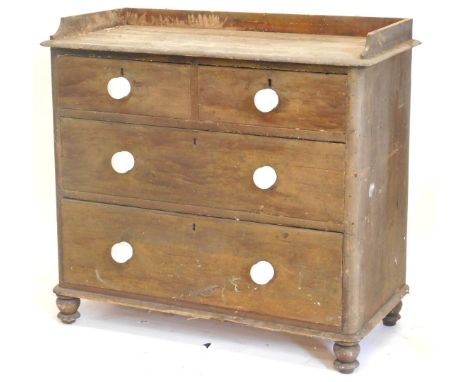 A Victorian pine chest of drawers, with a raised gallery above two short and two long drawers, each with white ceramic handle