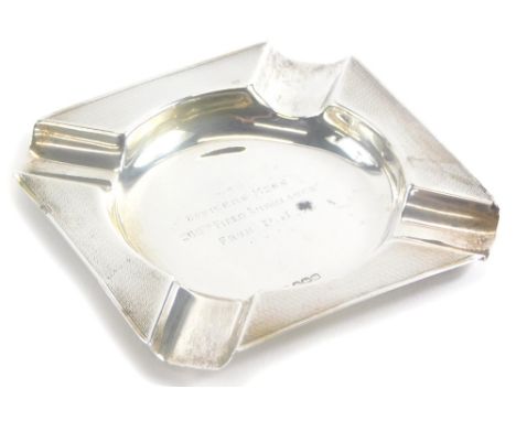 An Elizabeth II silver ashtray, of square form with engine turned decoration, inscribed to centre 'Officers Mess 206th Field 