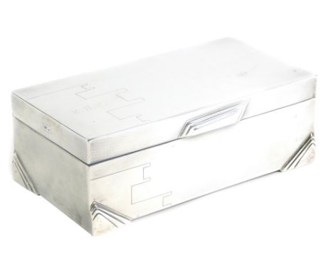 A George V silver cigarette box, of Art Deco design, with engine turned decoration and engraved monogram to lid for E.R.F., t