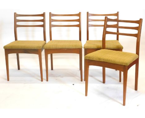A set of four 1960s/70s teak ladder back dining chairs, each with a padded seat on square tapering legs. The upholstery in th