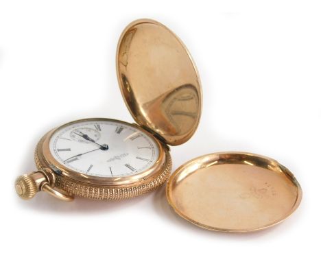 A fob watch, with engraved floral casing, white enamel dial, seconds dial and blue hands, bezel wind in a yellow metal colour