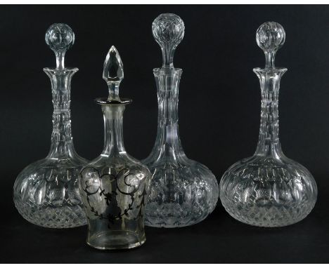 A set of three early 20thC cut glass decanters, each with orb stoppers and bulbous bodies, and another decanter with associat