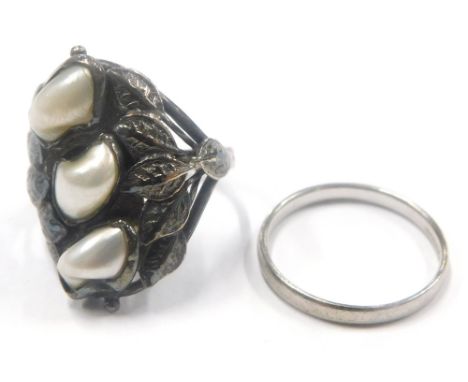 Two dress rings, to include a cultured pearl and leaf design dress ring, white metal, unmarked, ring size I, 4.3g, together w